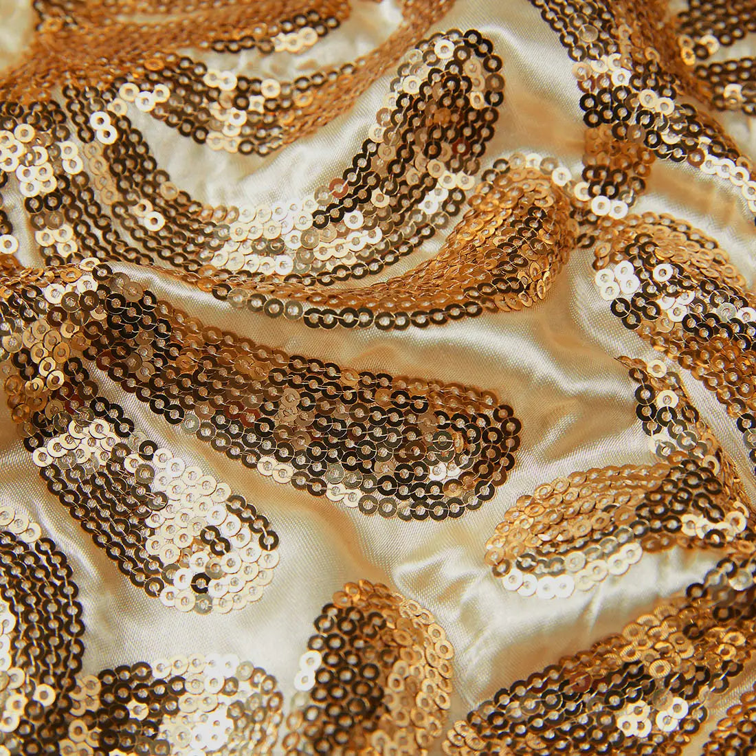 Cream-colored satin gold sequin mens suit jacket featuring intricate paisley patterns with shimmering gold and silver sequins in a retro floral blazer design.