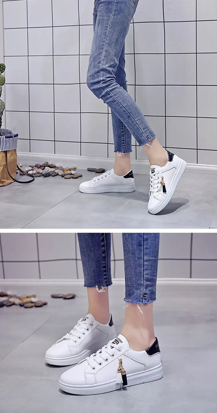 white leather low-top tassel sneakers with black accents and a small gold-colored zipper pull, breathable sports shoes.