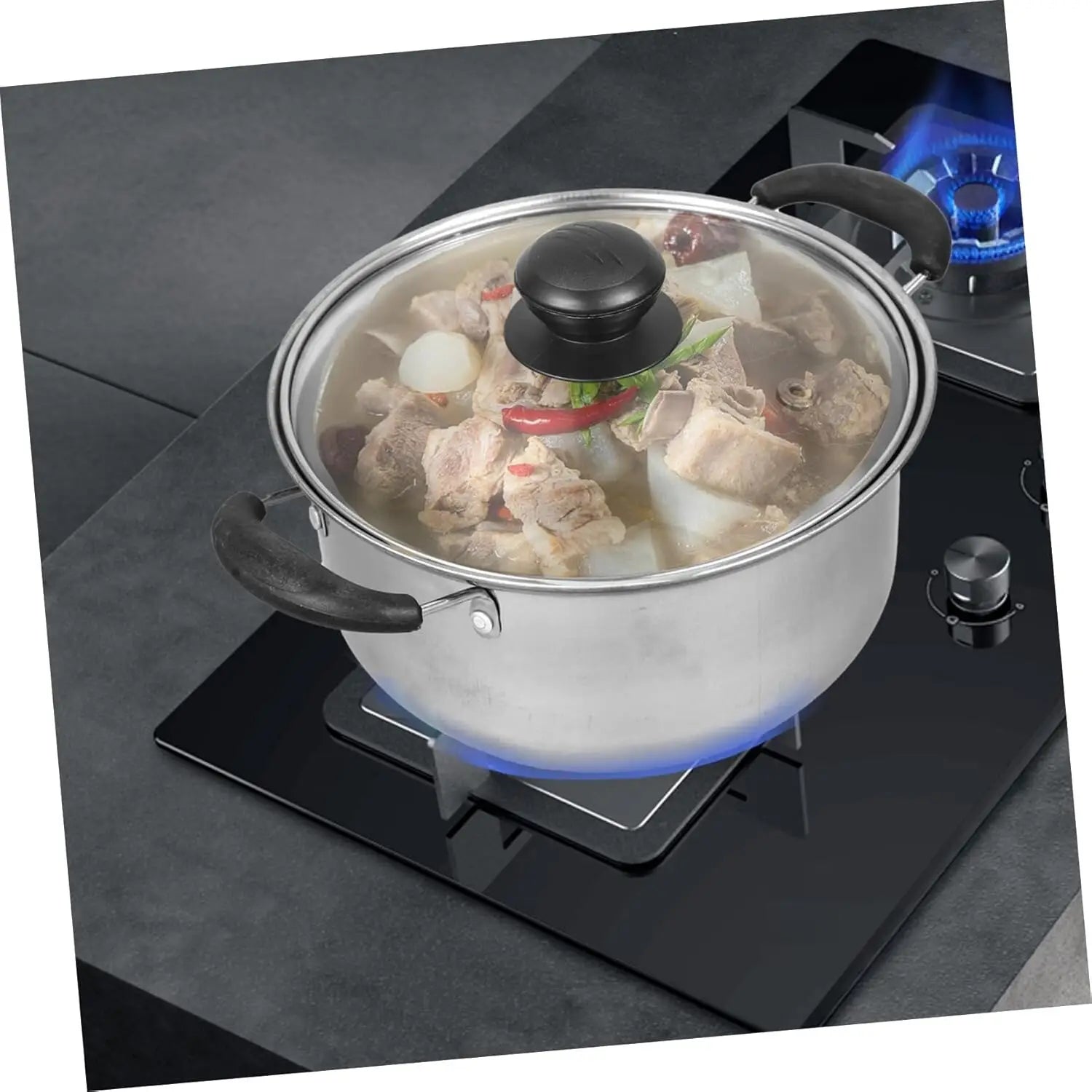 Silver stainless steel pot with black handles and a clear glass lid with black knob simmering broth with meat and vegetables from a stainless steel induction cookware set 5 pieces