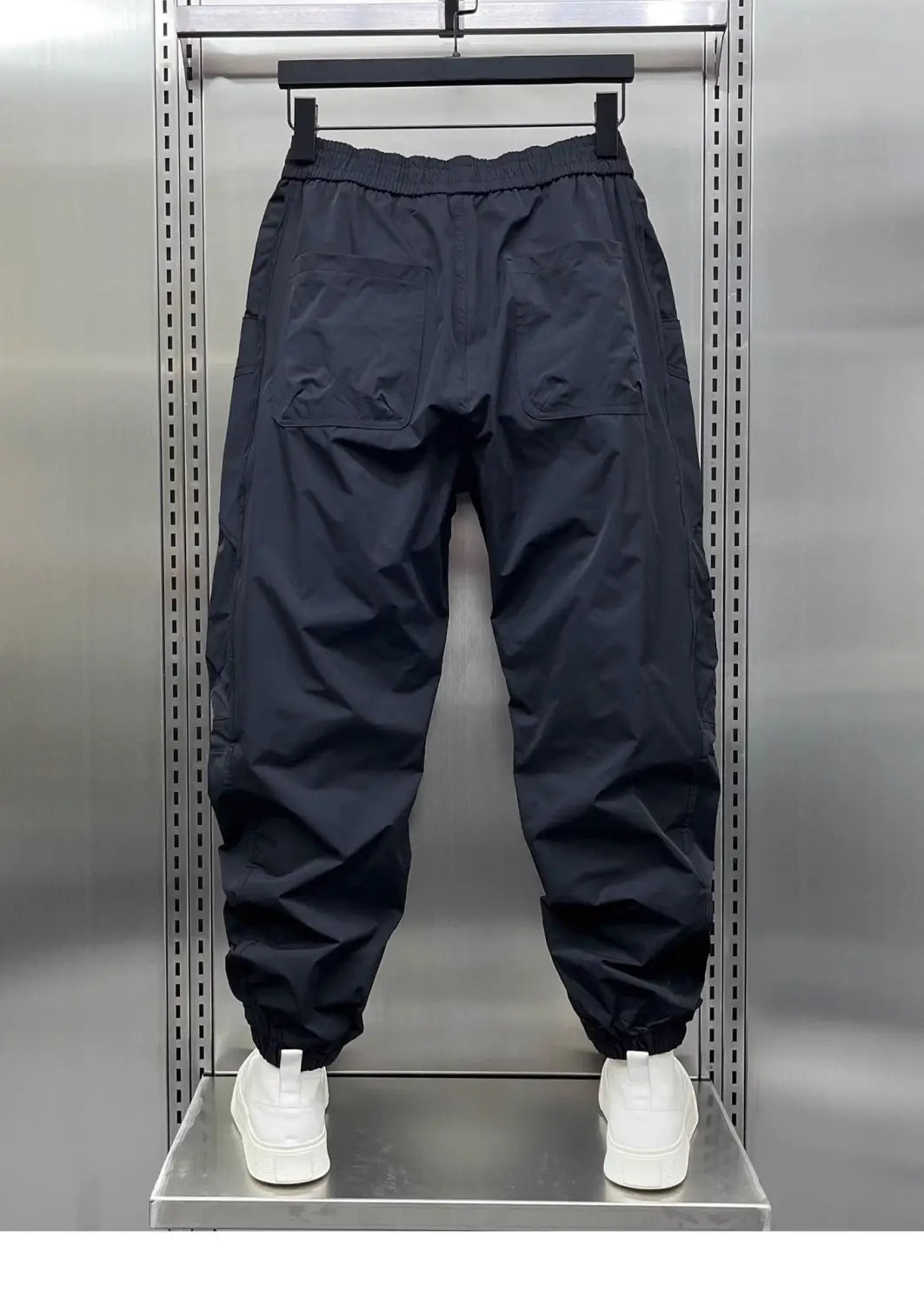 men’s tapered cargo joggers in black lightweight nylon with elastic waistband and drawstring pockets