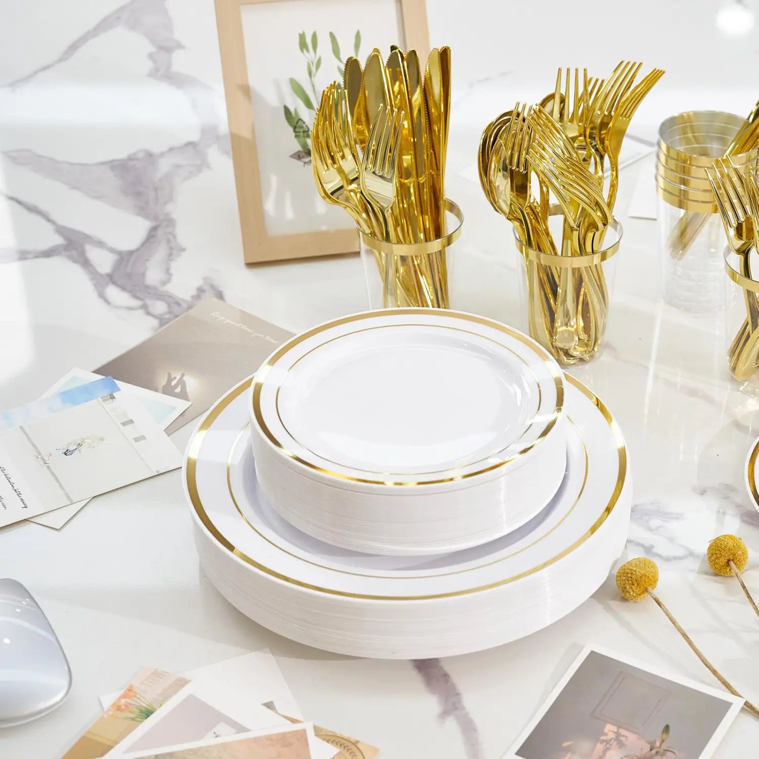 White plastic tableware set with elegant gold rim ceramic plates stacked for use by 50 guests.
