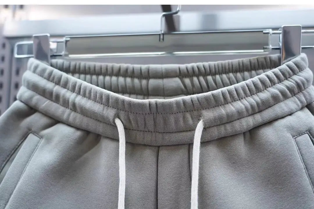mens casual solid color sweatpants in gray featuring a ribbed elastic waistband with white drawstrings for comfortable everyday wear