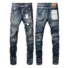 Men’s distressed slim fit patchwork denim jeans in dark blue with ripped knees and a faded wash.