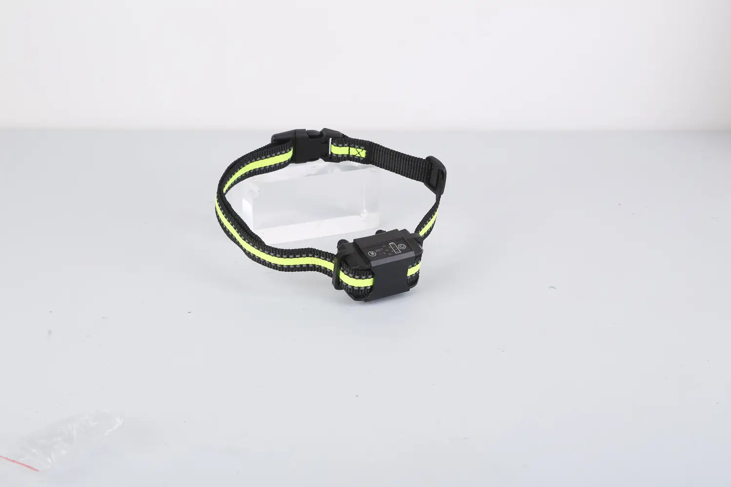 Black and neon yellow reflective rechargeable smart dog bark collar with a black plastic buckle and control unit featuring dual training modes.