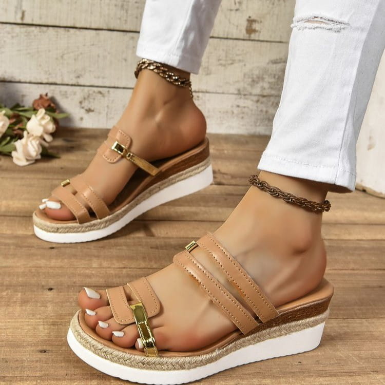 Tan leather wedge sandals with woven espadrille heel and gold-tone buckle metal accents.