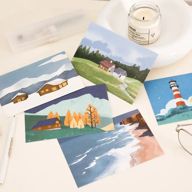 Set of five winter travel diary postcards featuring illustrated cozy countryside scenes lighthouse by the sea and autumn landscapes in soft pastel tones on matte paper for wall decor.