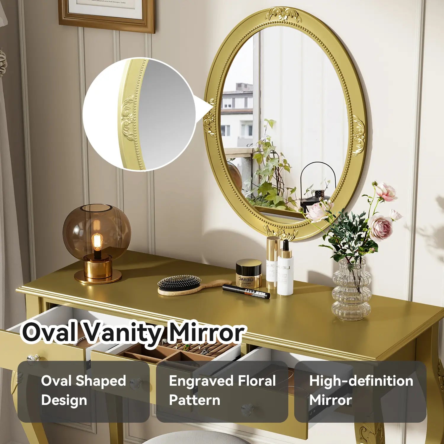 Gold makeup vanity desk featuring an oval gold mirror with an ornate frame engraved with a floral pattern and three drawers.