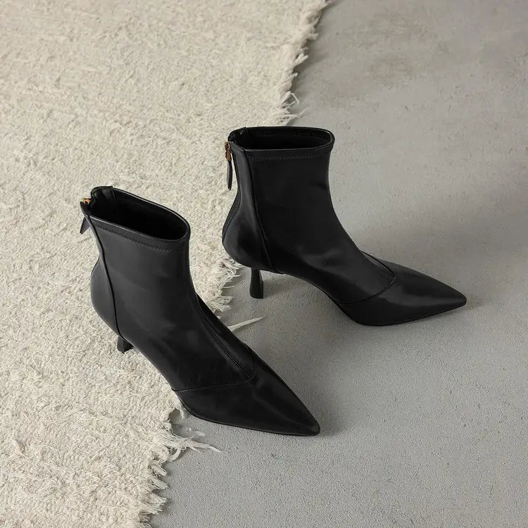 Black leather pointed toe cowhide stiletto ankle boots with a slim heel and zipper.