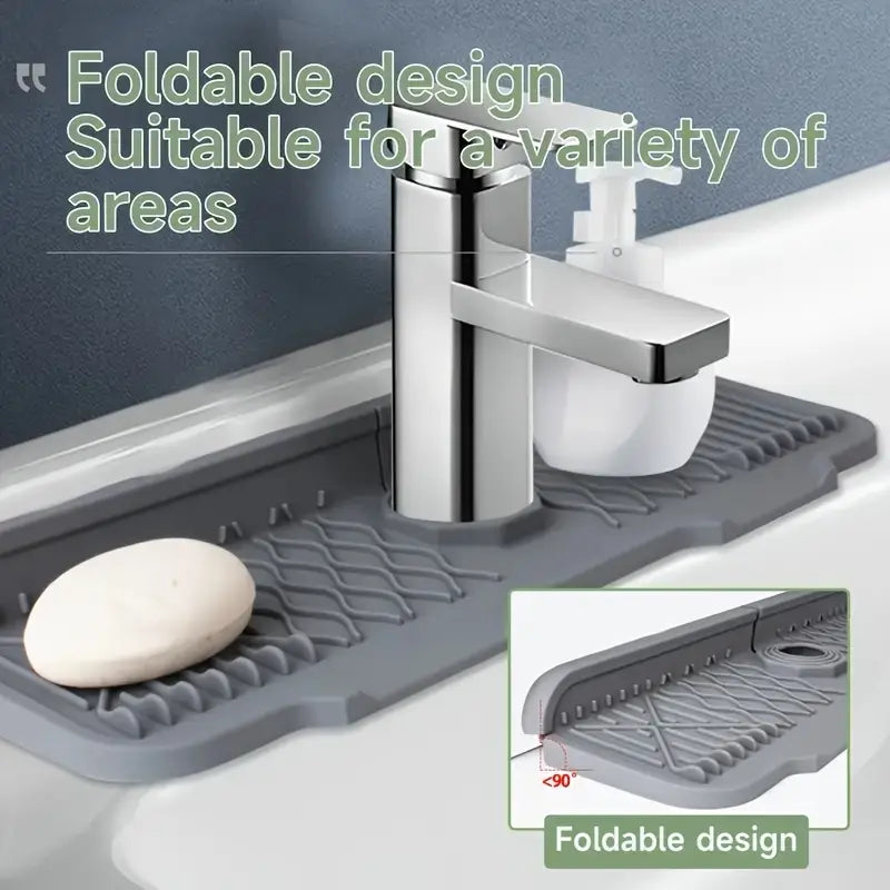 Gray foldable silicone self draining kitchen sink faucet mat with a textured grid-like surface for grip and drainage.