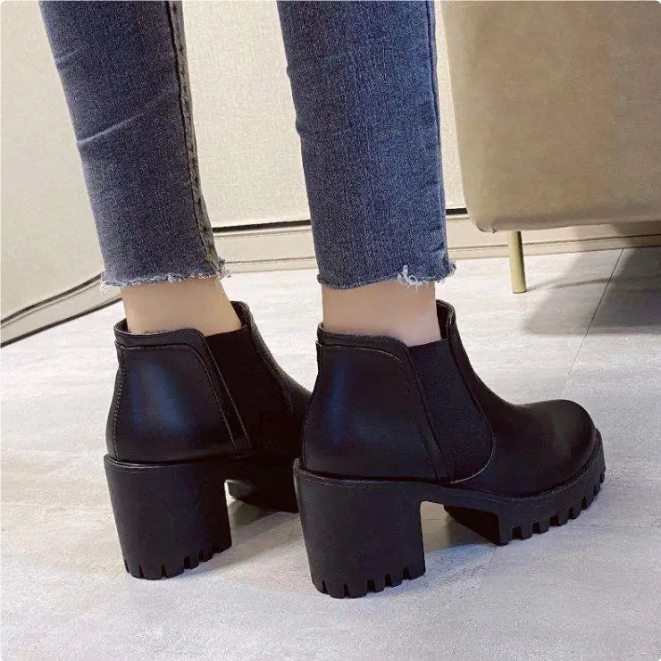 Women black leather chunky heel ankle boots featuring black leather material and chunky textured block heels.