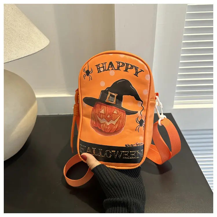orange embroidered halloween floral and pumpkin crossbody bag featuring a jack-o-lantern wearing a witch’s hat with black spider details and happy halloween text in contrasting colors