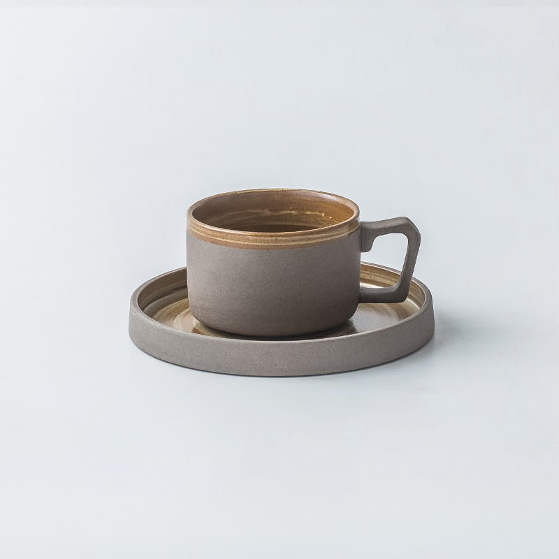 Gray ceramic espresso cup with a warm gold rim and matching saucer from a retro Japanese dinnerware ceramic tableware set featuring minimalist design.