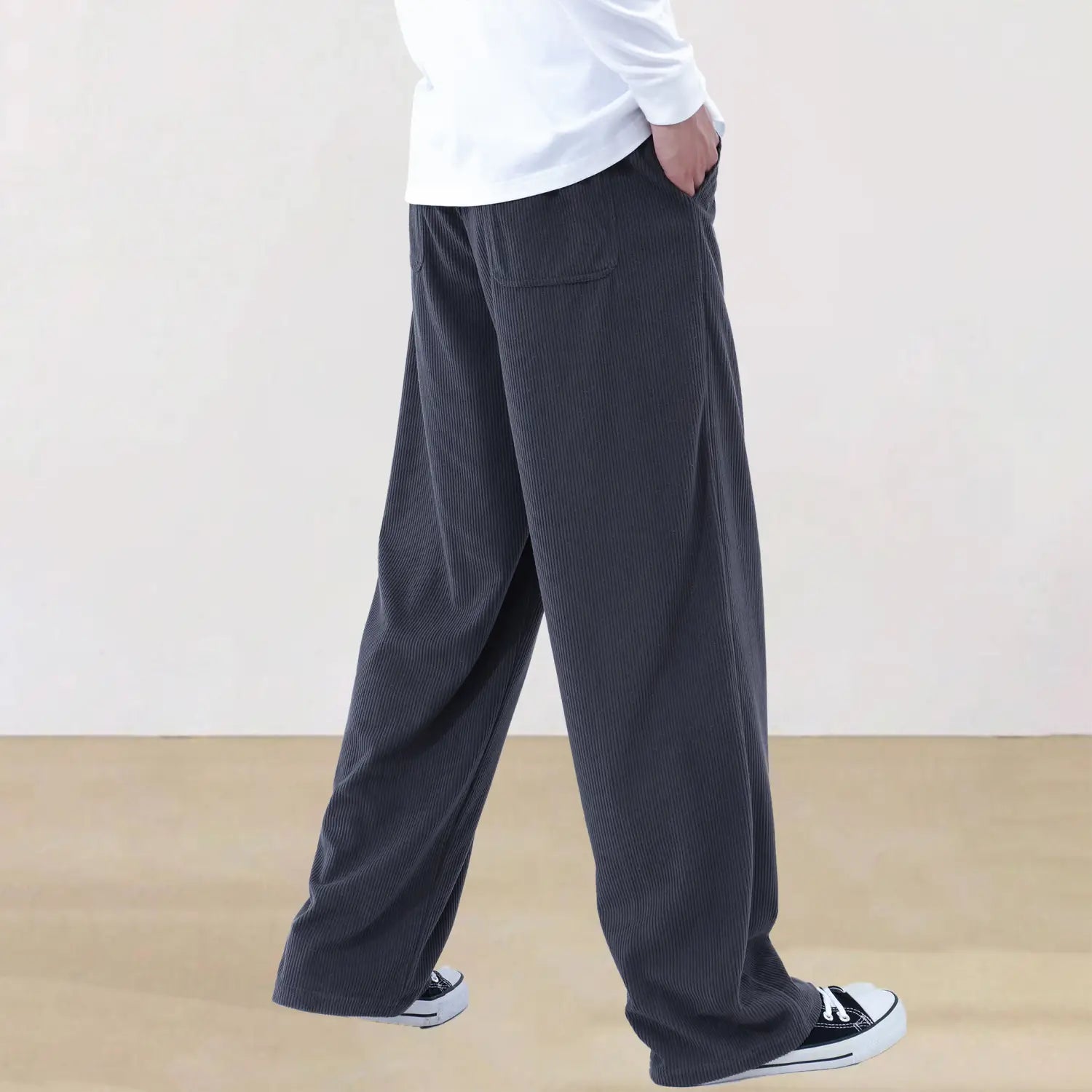 Men’s slim fit dark gray corduroy sporty drawstring casual pants with a relaxed wide-leg cut and subtle vertical ribbing.
