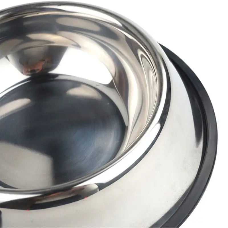 A shiny stainless steel pet bowl with a black non slip rubber base designed for stable feeding.