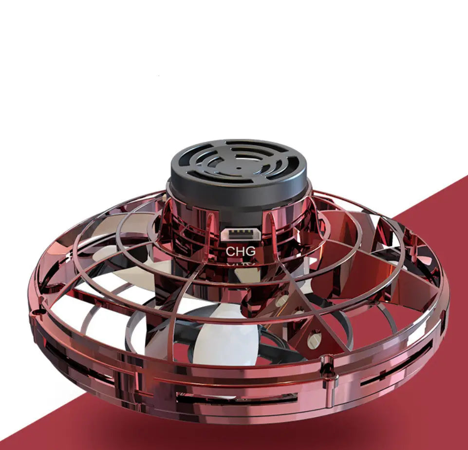 Red metallic flying ufo spinner led mini drone with black central charging port and circular fan blades designed as a fingertip gyro toy.