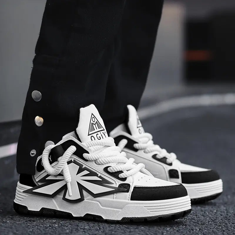 Black and white chunky sneakers for men Harajuku low top shoes with bold geometric design accents thick rubber soles and a distinctive triangular logo on the tongue.