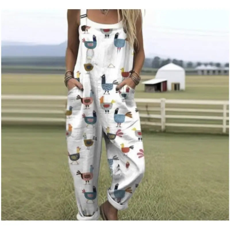 White cotton printed suspender overalls featuring a playful pattern of colorful cartoon chickens in various poses and hues for casual wear.