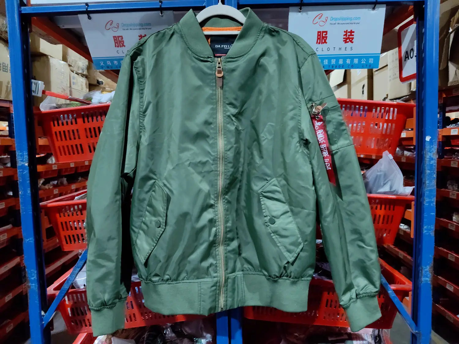 olive green ma1 pilot bomber jacket with a red patch on the left sleeve and silver zipper details designed for casual wear.