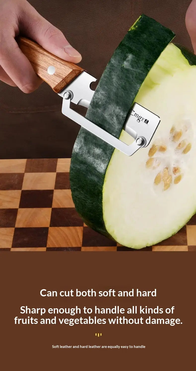 A stainless steel vegetable peeler with a wood handle slicing through a green zucchini.