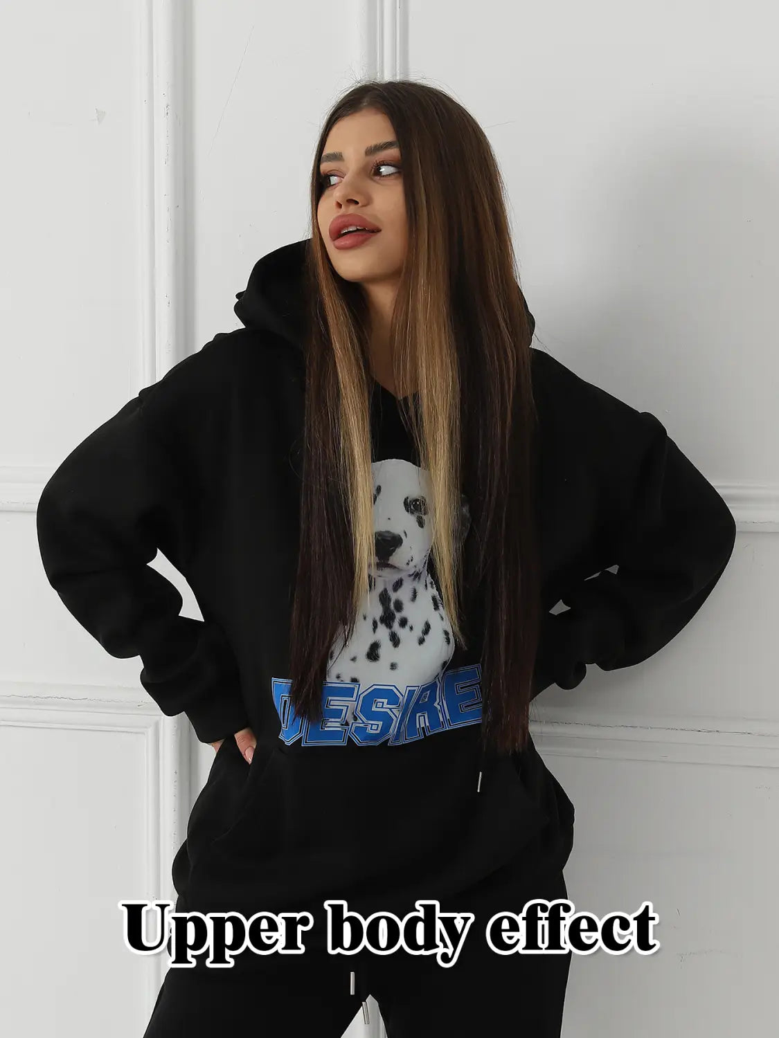Black oversized women’s hoodie made of soft material featuring a white dalmatian dog graphic with blue lettering and a cat ear hood.