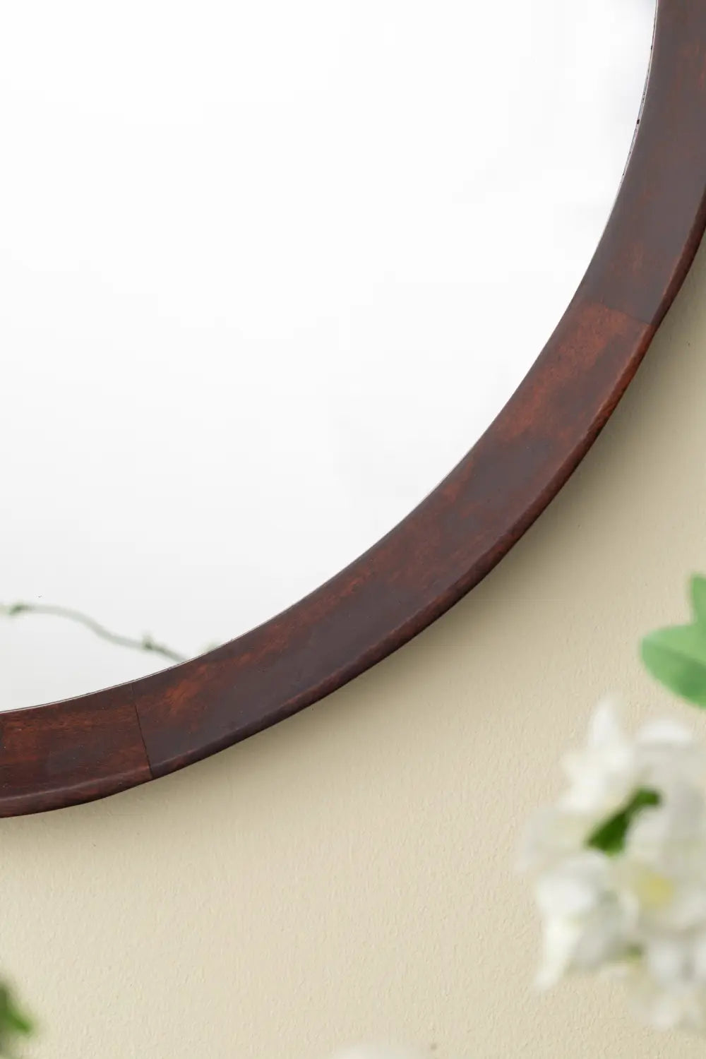 A 20 inch round mirror with a dark brown wooden mango wood frame suitable for wall mounting.