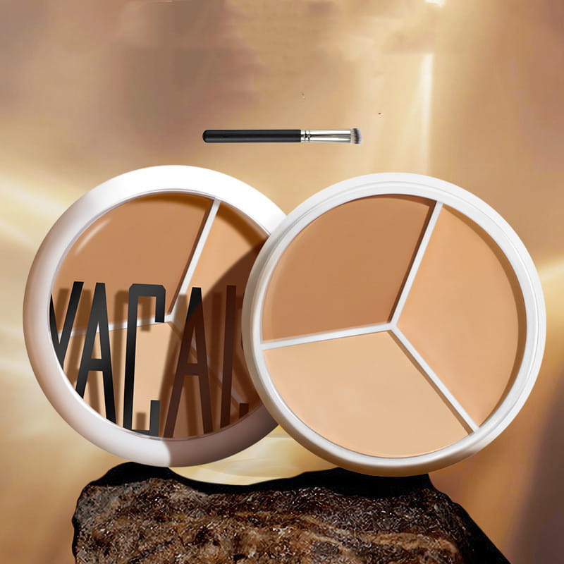 White circular three-color concealer palette with three-toned beige shades separated by white dividers and accompanied by pro 270 brush for professional makeup application.
