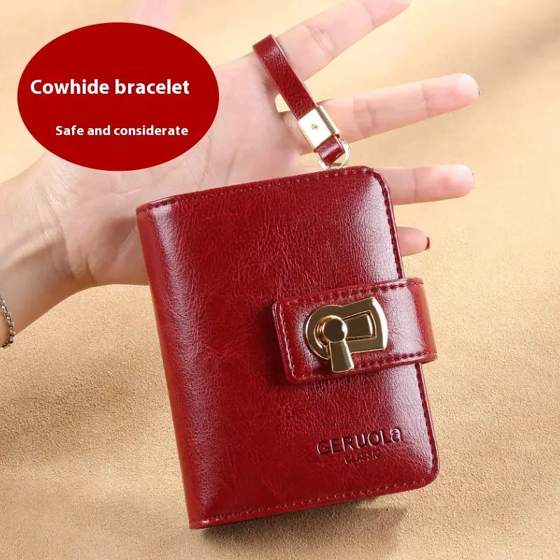 Red cowhide women’s leather RFID large capacity buckle wallet with gold-tone keyhole clasp and matching strap.