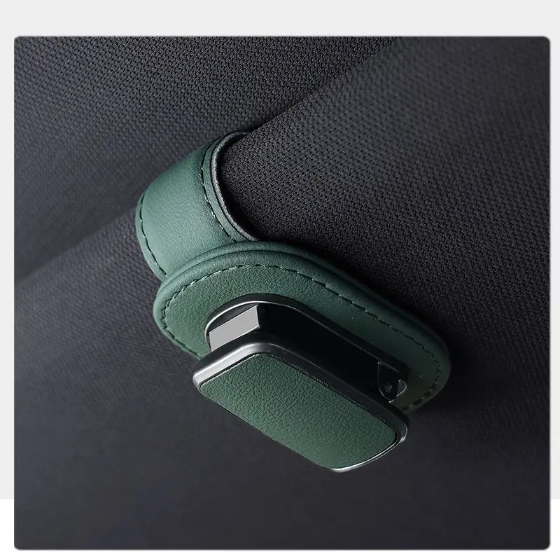 Leather car glasses clip holder featuring a green leather seat belt clip with a sleek black metal clasp.