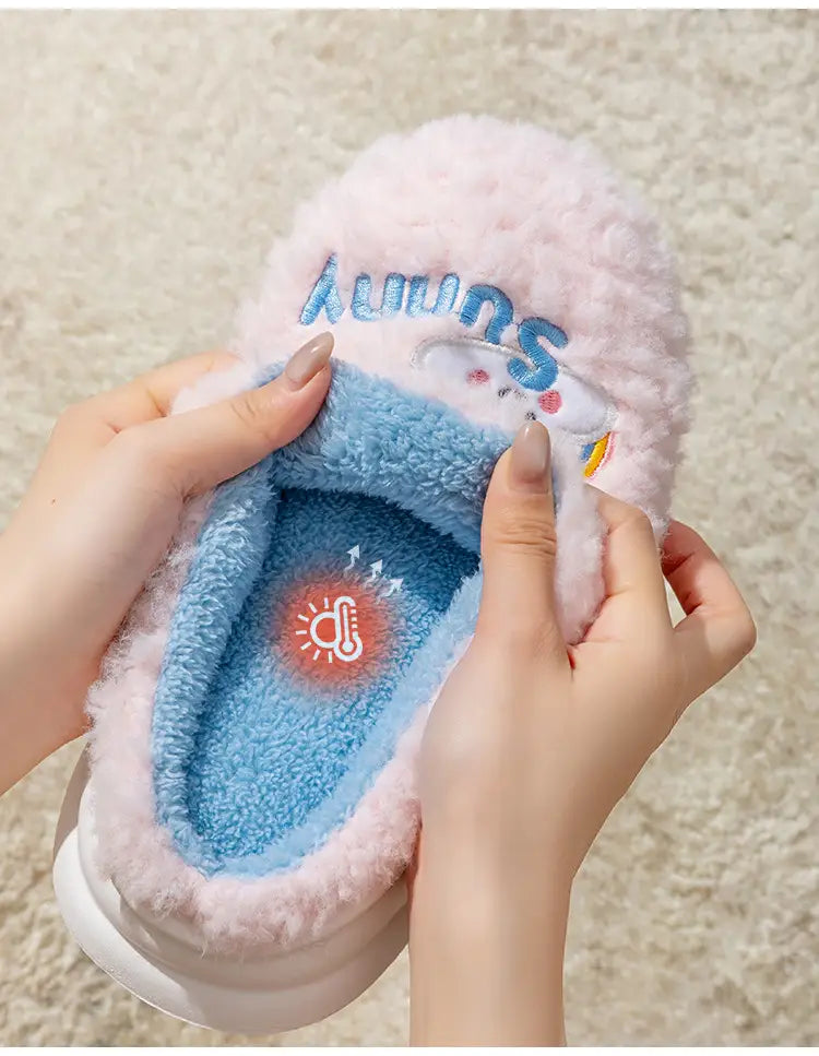 Pink fluffy plush cotton slipper with blue interior and embroidered sunny text from the smiling cloud and rainbow collection.