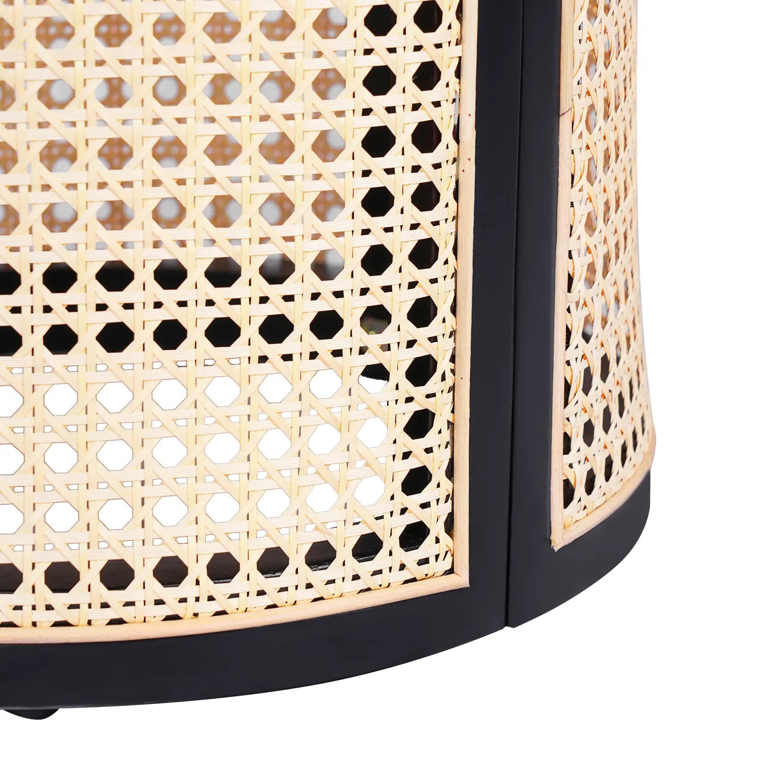 Black rattan end table with round woven wood nightstand design featuring a black-framed cylindrical lantern with a natural cane weave pattern.