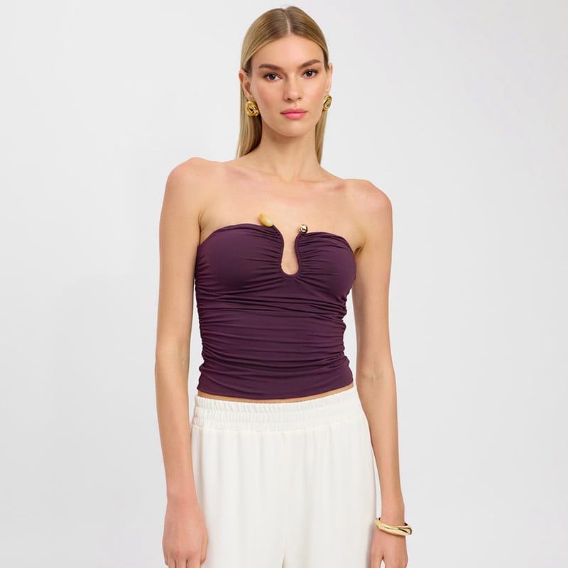 Purple ruched strapless keyhole crop top with gold-tone button accents and a central cutout.
