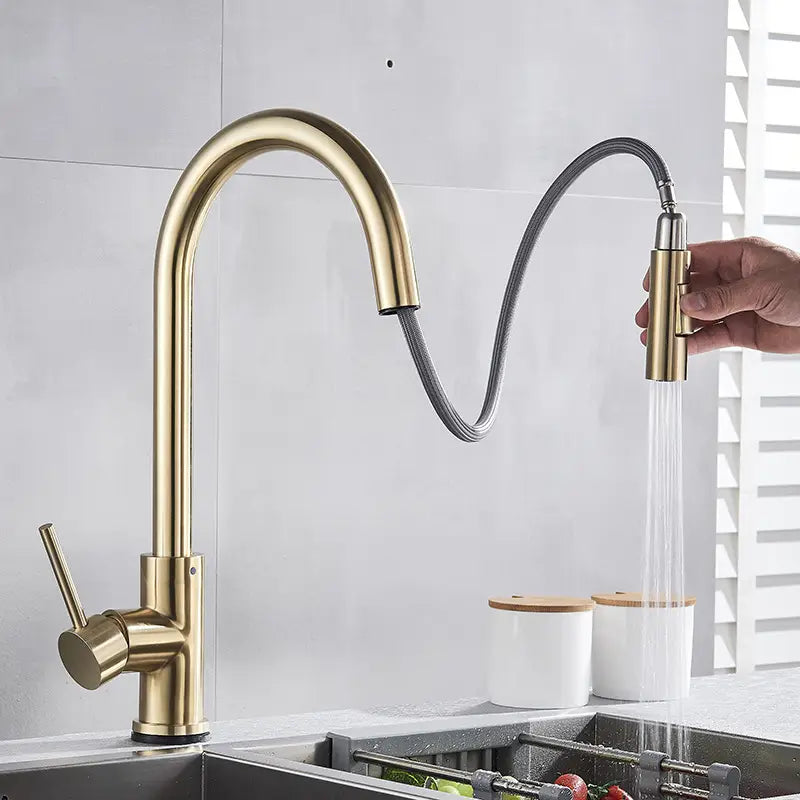 gold-toned golden smart touch pull out kitchen faucet with a sleek curved spout and flexible hose for convenient kitchen use.