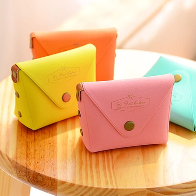 pink envelope-style coin purse made of pastel leather and pvc with gold-tone button closure and embossed logo from the Macaron Pastel Leather and Pvc Coin Purse Set