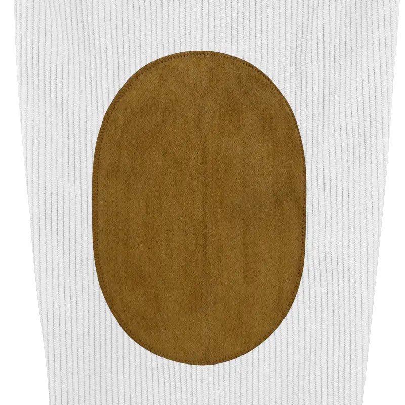 tan suede elbow patch on white corduroy fabric of a slim fit corduroy patchwork pullover with contrast accents