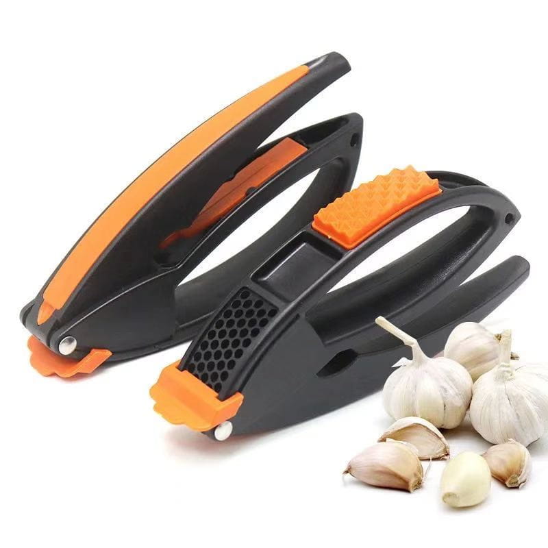 Garlic press and vegetable peeler kitchen tool set featuring a black and orange garlic press with textured grip handles and a perforated crushing plate.