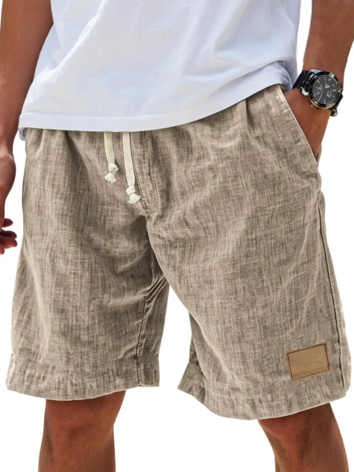 Beige linen holiday shorts for men with a drawstring waist and a small tan patch on the side designed for a retro breathable loose fit.