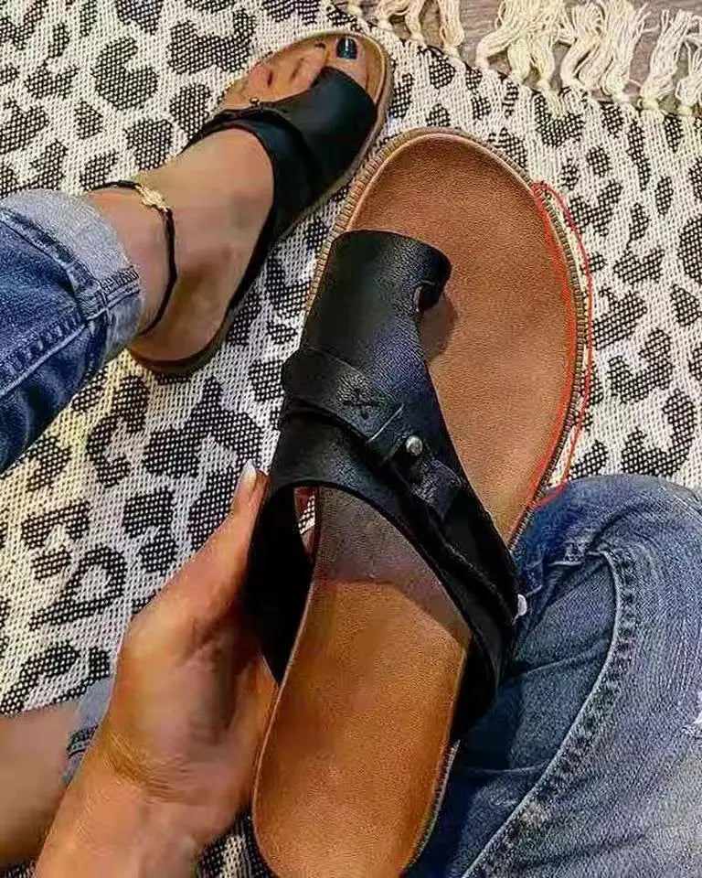 Black leather thong sandal with brown insole and silver buckle detail for women casual flat platform slides.