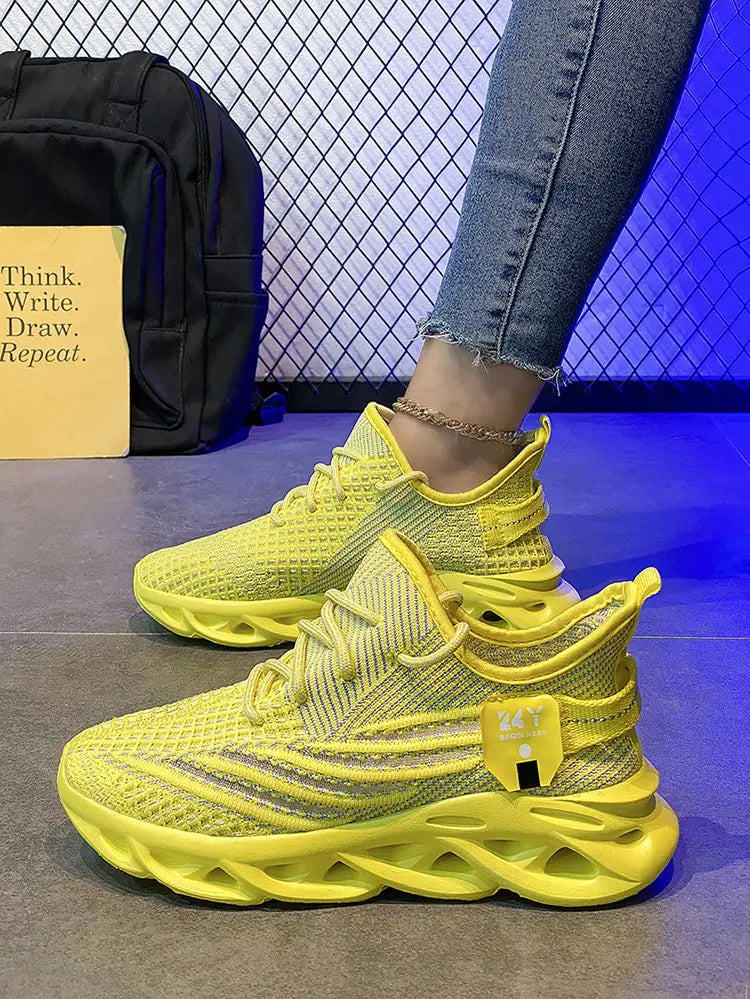 Bright yellow flyknit mesh platform running shoes for men featuring a chunky sculpted sole and subtle silver accents.