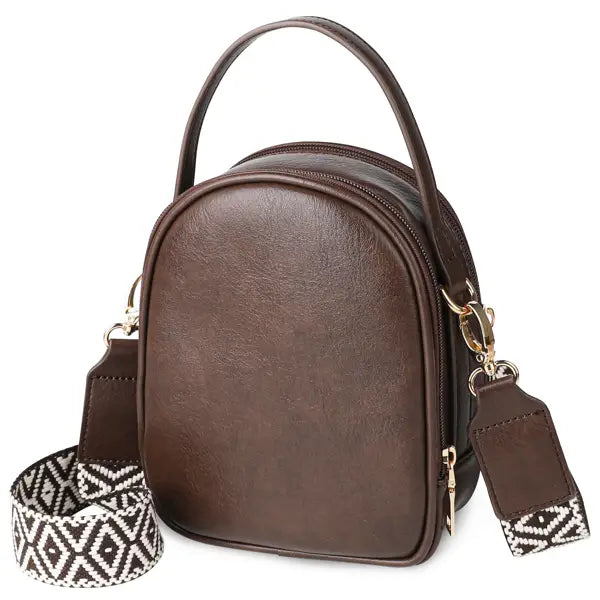 Brown faux leather mini crossbody bag with gold hardware and a geometric-patterned adjustable strap.
