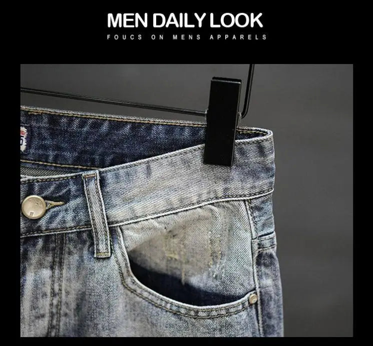 Distressed maple leaf denim shorts in blue denim with a faded wash and visible stitching.