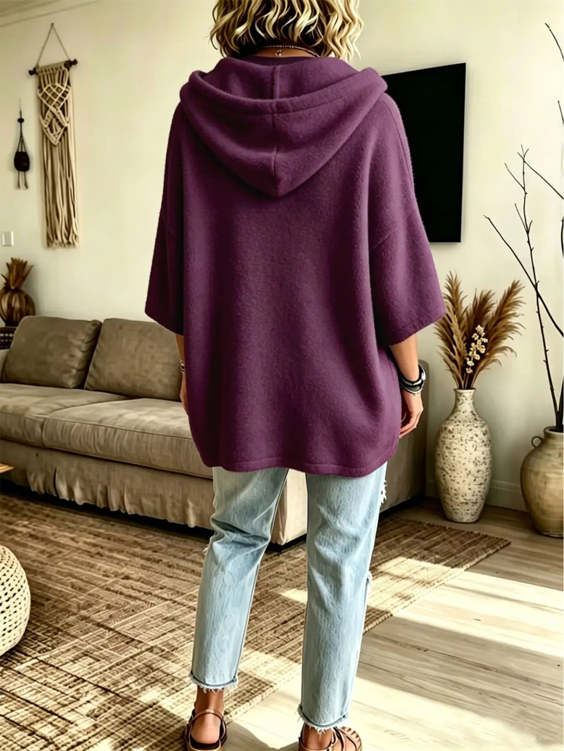 A cozy deep purple oversized fleece hooded top with a soft slouchy fit and three-quarter sleeves.