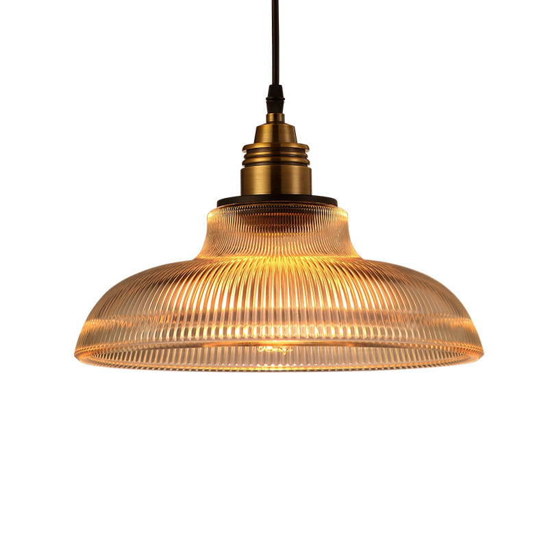 A warm-toned ribbed glass pendant light with a brass metal fixture designed for stylish interior lighting.