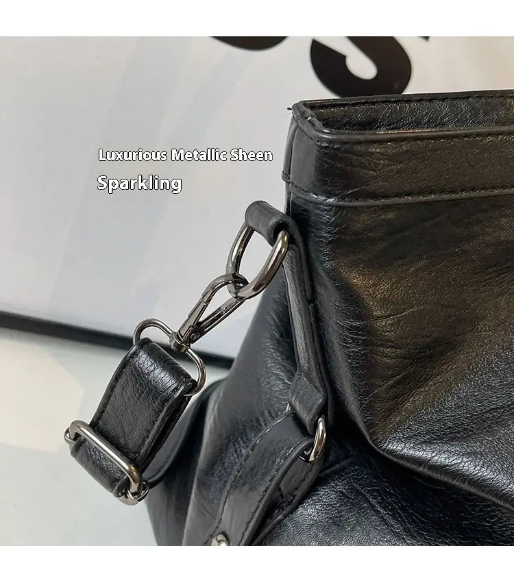black leather shoulder bag with metallic chain strap and silver-toned hardware featured in a brown leather star studded retro messenger bag collection