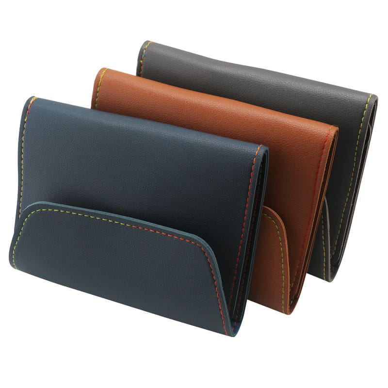 three compact leather wallets in navy brown and black with contrasting colorful stitching featured in a 16 piece professional manicure and pedicure kit