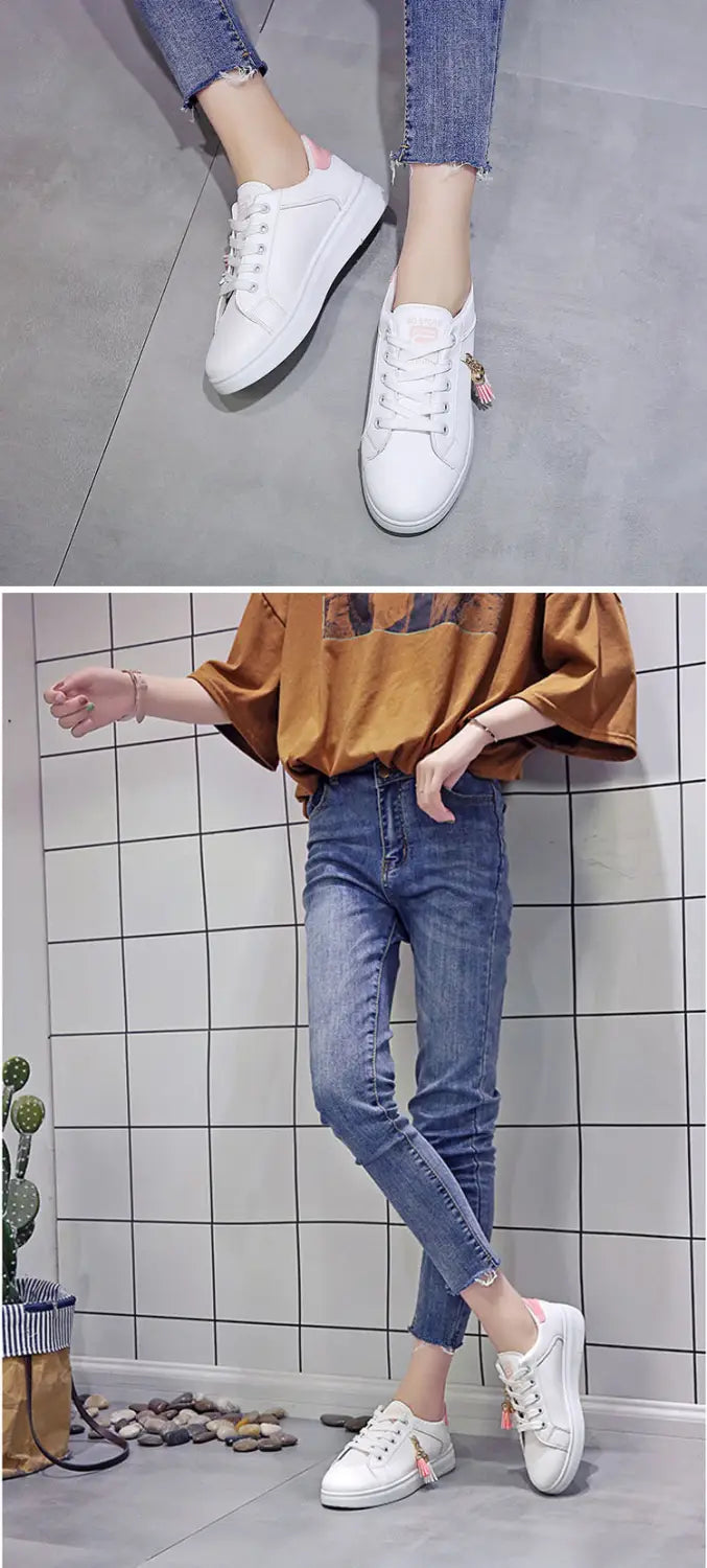 White leather tassel platform sneakers with breathable design and subtle pink accents on the heel tab shown from the back side.