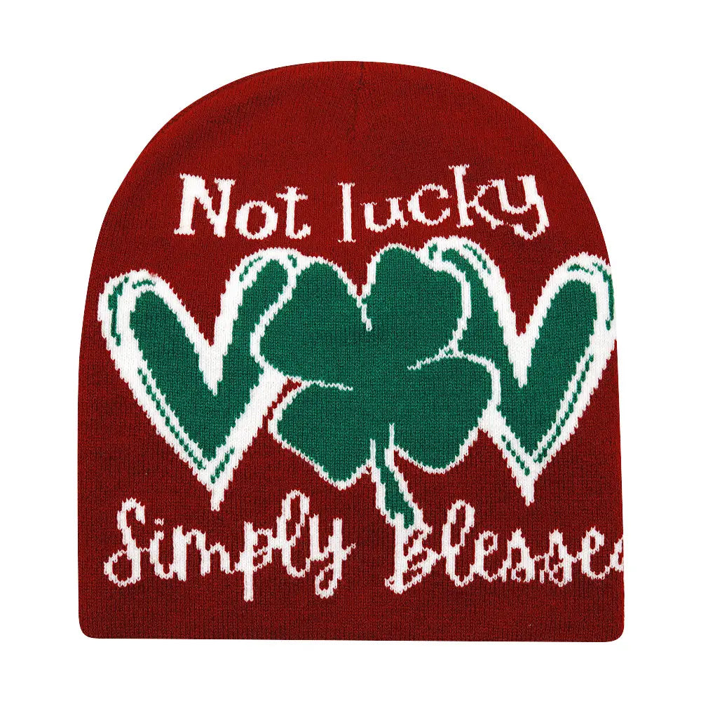 Red knitted beanie winter warm hat featuring a green four-leaf clover and white text reading not lucky above and simply blessed below.