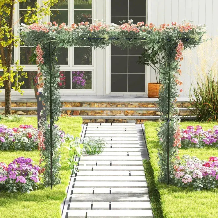Black metal garden arbor archway for climbing plants 81in adorned with lush green vines and pink flowering plants.