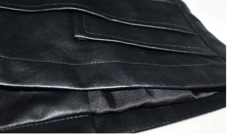 Black leather wallet with stitched seams and satin-lined interior paired with a leather moto jacket with high collar and puff sleeves.