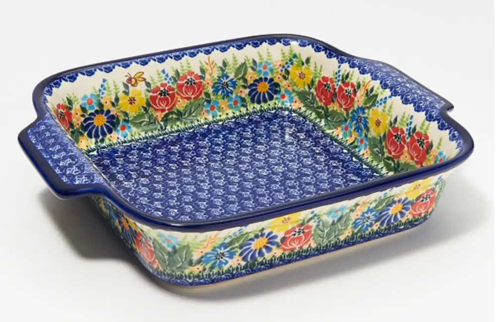 Hand painted 9x9 floral polish pottery square baker with vibrant floral pattern blue handles and speckled interior