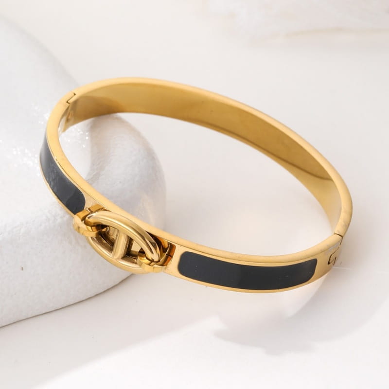 Women h bangle gold enamel minimalist bracelet featuring a gold-tone bangle with black enamel accents and a central interlocking cc logo clasp perfect as a bangle fashion bracelet.